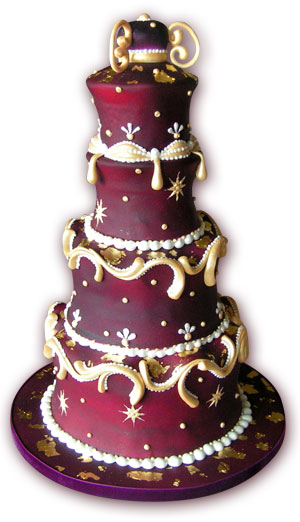 A Bollywood style wedding cake with real gold leaf and sugar curls with 
