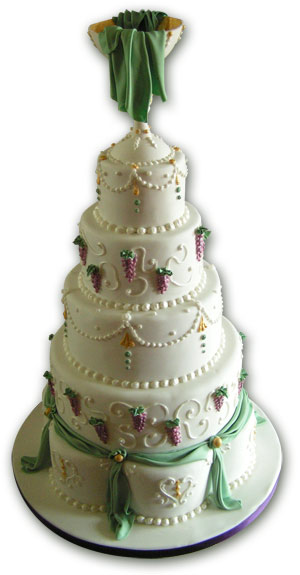 Wedding cake in white purple and green with chalice and fabric